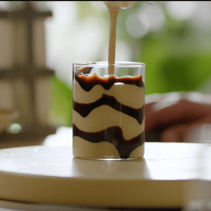 Frozen Banana Milkshake made with Absolut Vodka, Kahlúa and Cream Liqueur, drizzled with chocolate sauce.