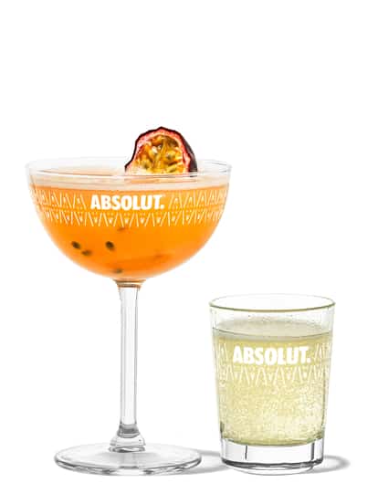 Pornstar Martini with a passion fruit half in an Absolut branded glass and champagne shot.
